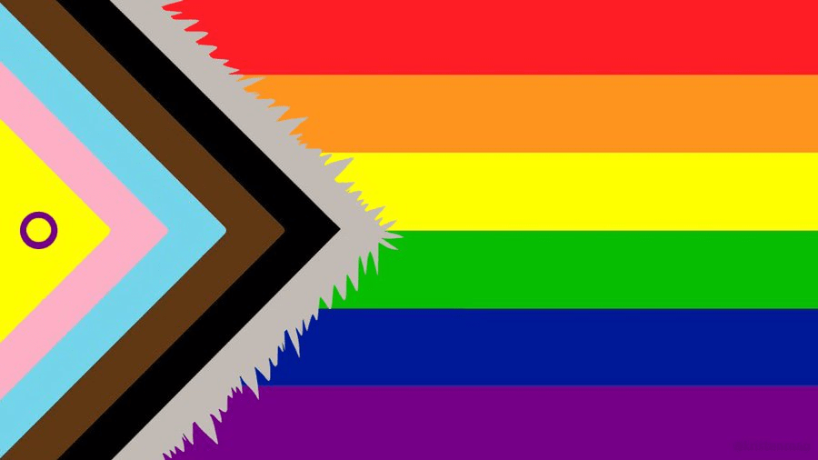 Progressive pride flag featuring rainbow stripes alongside a chevron design in multiple colors. Represents inclusivity in the LGBTQ+ community.